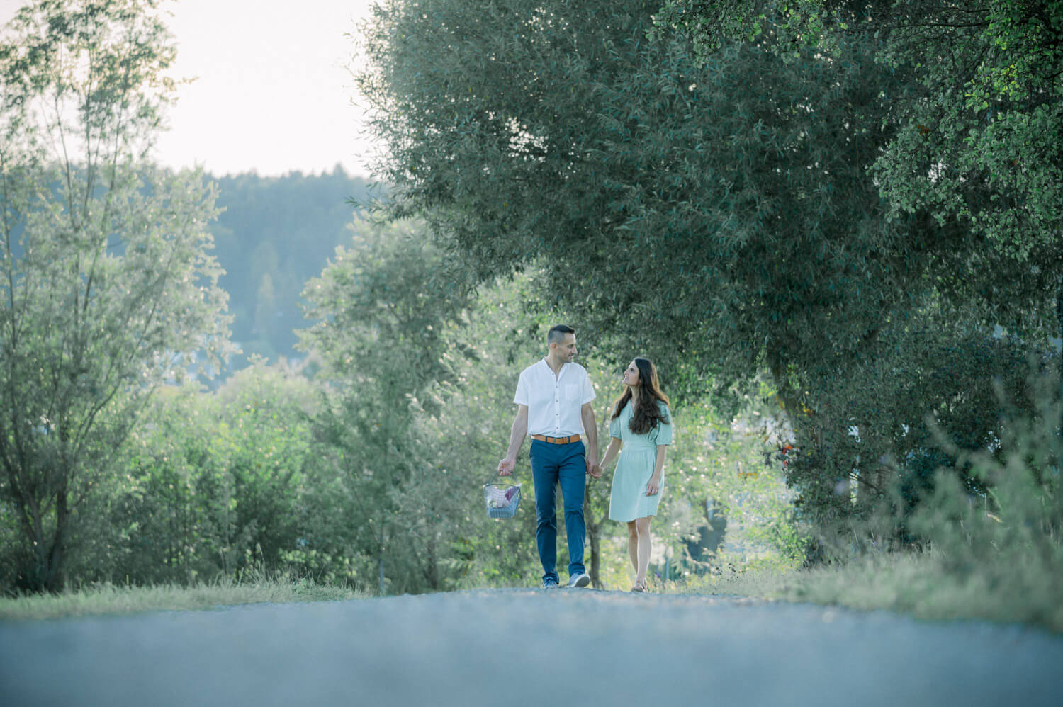 Paar bei natürlichem Engagement Shooting beim Spaziergang in ruhiger Lichtstimmung